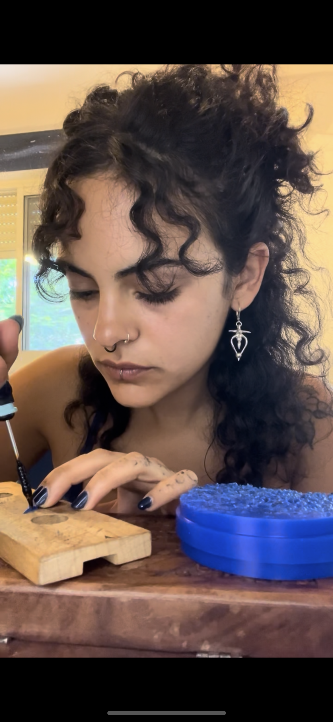 Carving the design into blue wax by hand